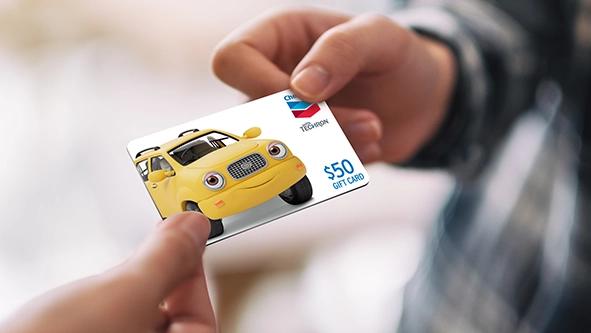 Chevron gas gift card being handed to someone.