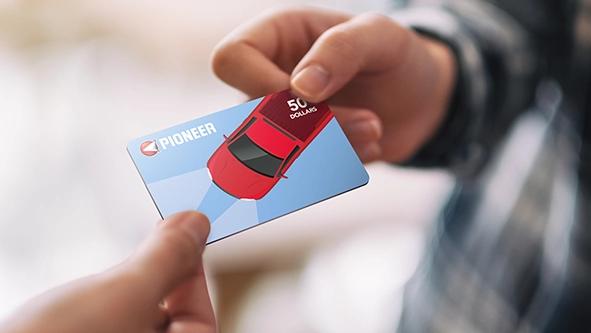 Hand distributing Pioneer gift card.